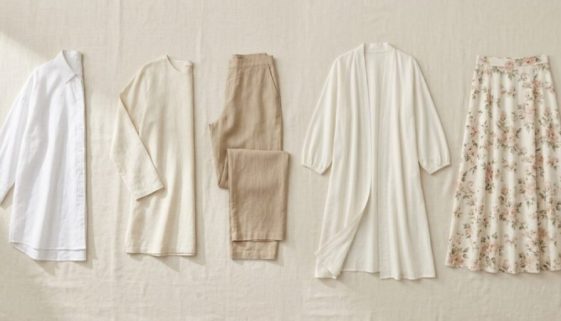 Flat lay of summer wardrobe essentials: linen shirt, wide-leg trousers, floral midi skirt, and ivory kimono
